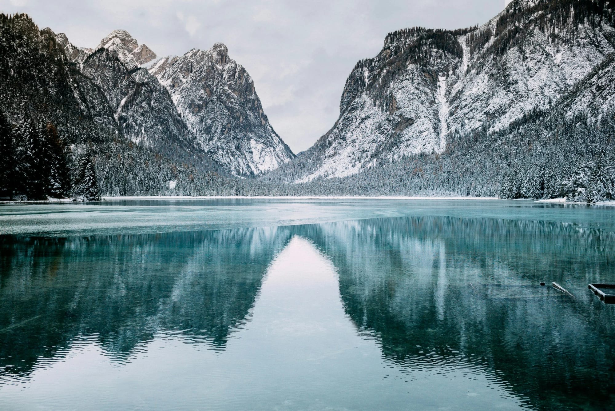Snow-dusted mountains reflected in a calm alpine lake